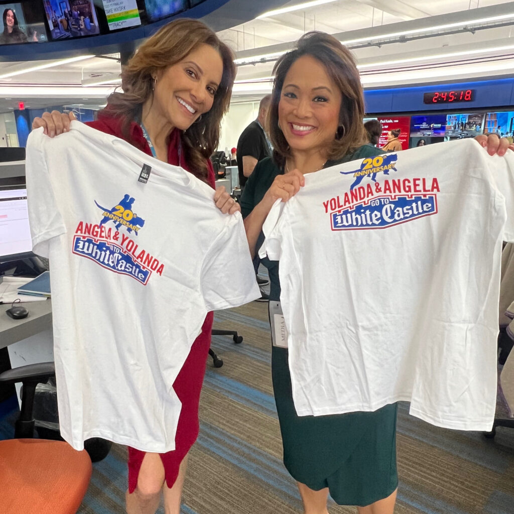 Yolanda & Angela hold White Castle 20th Anniversary t-shirts.